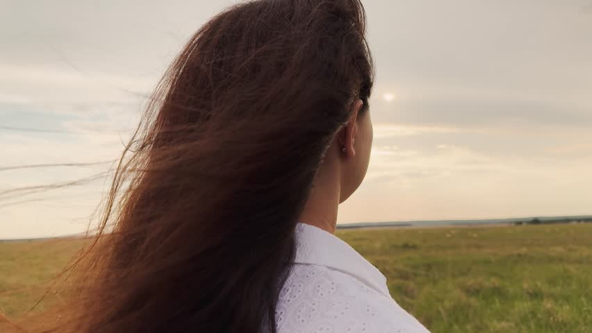 close-up, beautiful young girl, wind in her hair, with closed eyes, enjoying vacation, wind blowing in woman