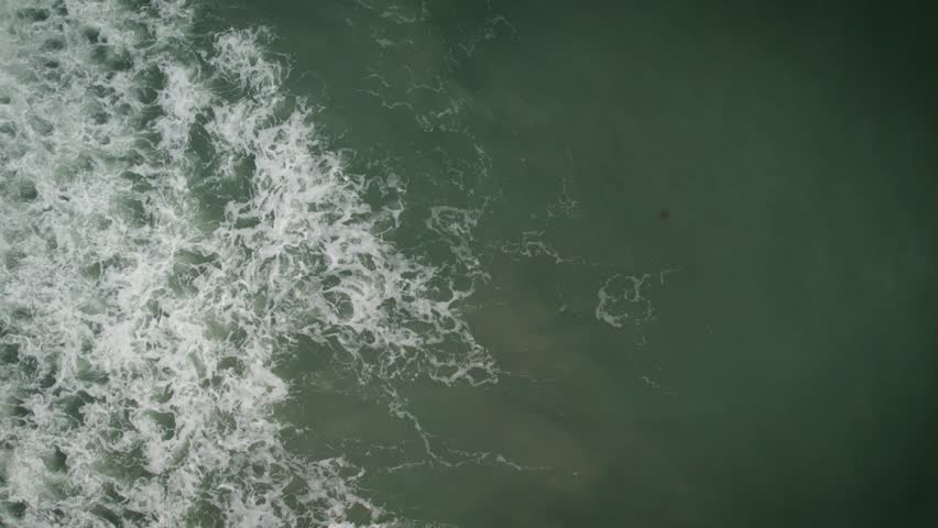 A drone footage of the ocean waves at the beach of Ormond Beach City in Volusia County, Florida, USA