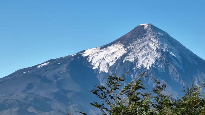 A scenic view of Osorno volcanic mountain against blue sky lying between Osorno Province and Llanquihue Province in Los Lagos, southern Chile