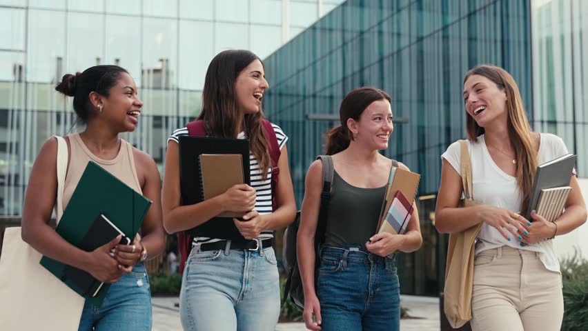 Cheerful multiracial student girls walking after university classes - Diversity in Higher Education