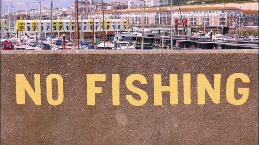 No Fishing Notice Text Yellow Sign Warning Stone Wall Harbour Boats Maritime