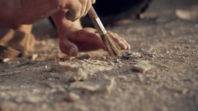 Archaeologist working with a brush - Powered by Shutterstock - Get 15% off with code: PIKWIZARD15