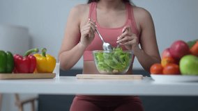 Woman preparing a vibrant salad with fresh vegetables and fruits on a kitchen table. Bell peppers and apples add color to the healthy meal prep - Powered by Shutterstock - Get 15% off with code: PIKWIZARD15