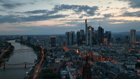 Dolly Flight through Frankfurt am Main, Germany. Skyline. New Skyscrapers. Urban Canyon in Sunset or Sunrise Light. Aerial Pedestal in Establishing Night Drone Shot. Glowing street lights - Powered by Shutterstock - Get 15% off with code: PIKWIZARD15