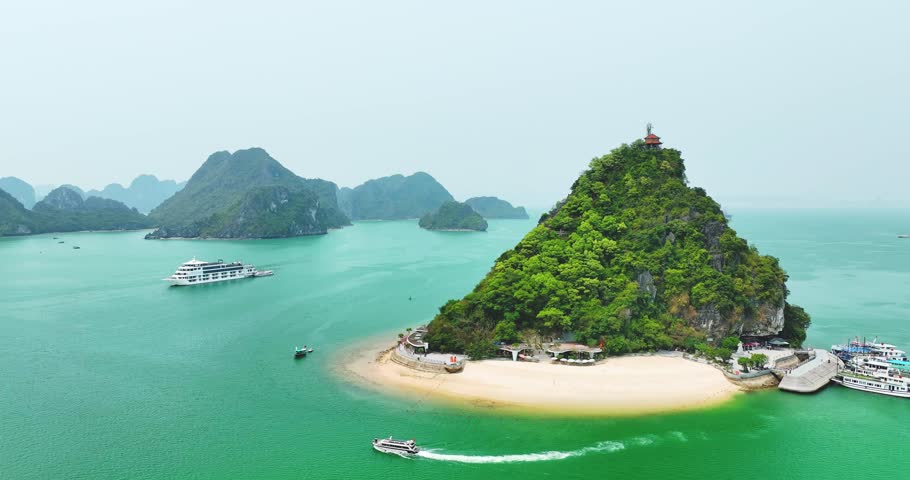 Aerial view of Ha Long bay during daytime beautiful emerald green water. This is the UNESCO World Heritage Site, a beautiful natural wonder in northern Vietnam, Southeast Asia nature background.