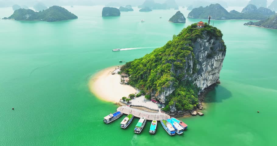 Aerial view of Ha Long bay during daytime beautiful emerald green water. This is the UNESCO World Heritage Site, a beautiful natural wonder in northern Vietnam, Southeast Asia nature background.