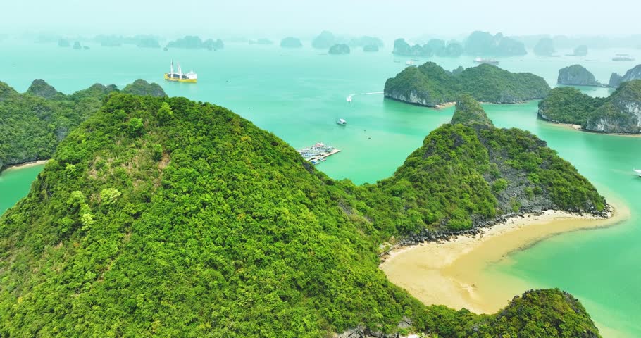 Aerial view of Ha Long bay during daytime beautiful emerald green water. This is the UNESCO World Heritage Site, a beautiful natural wonder in northern Vietnam, Southeast Asia nature background.