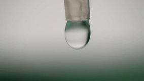 Liquid solution drops from syringe close up macro 4k shot slow motion selective focus - Powered by Shutterstock - Get 15% off with code: PIKWIZARD15
