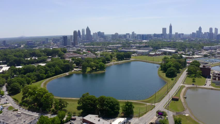 Drone shot of skyline views of Buckhead, Midtown and Downtown Atlanta from Waterworks reservoir