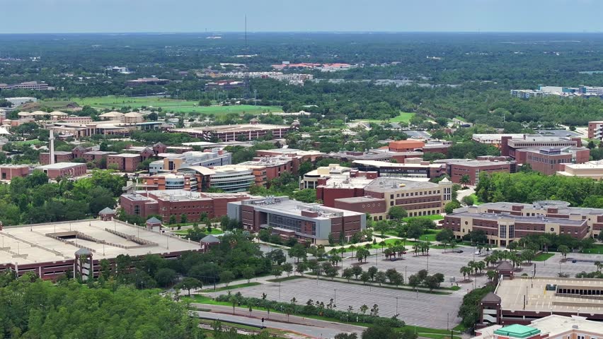 Drone view of the University of Central Florida campus with parking structures and academic buildings. Aerial perspective in Orlando, Florida.