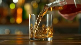Super Slow Motion of Pouring Whiskey into Glass . Filmed on High Speed Cinema Camera at 1000 fps , Camera Movement . - Powered by Shutterstock - Get 15% off with code: PIKWIZARD15