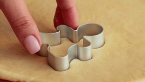 Female hands cutting out the rolled sugar Christmas Gingerbread shape cookies with cookie cutter close up - Powered by Shutterstock - Get 15% off with code: PIKWIZARD15