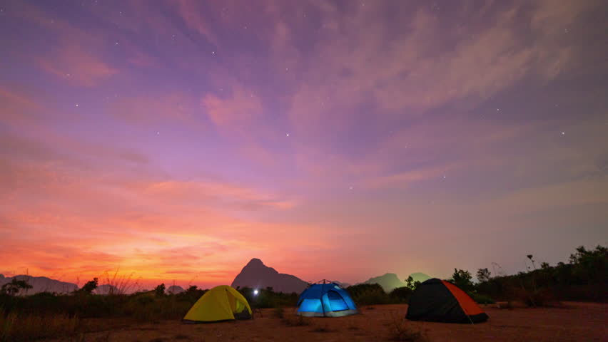 Time lapse The Milky Way rises in the sky above the camping ground.
Time lapse Milky Way on a cloudy night. 
Clouds followed by, obscuring the sky and stars. The night sky sparkles with stars.
