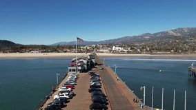 Forward Drone Shot Above Santa Barbara, California on Beautiful Summer Day, USA, Stearns Wharf, American flag   - Powered by Shutterstock - Get 15% off with code: PIKWIZARD15