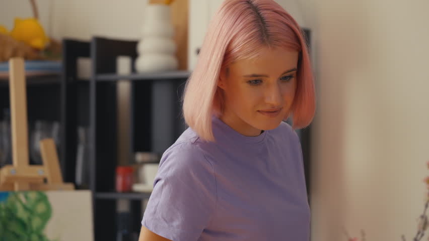 Young woman embracing her Asian boyfriend choosing hotel for vacation on laptop