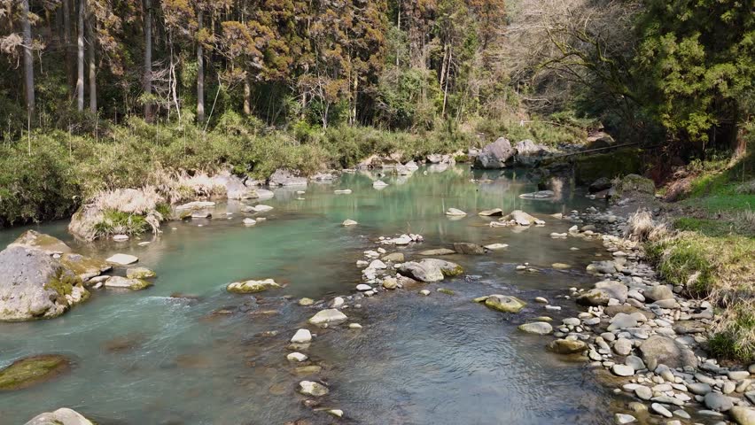 Japanese landscape Aerial drone shot of a green mountain stream and a magnificent rock covered with moss Tourist attractions in Miyazaki Prefecture