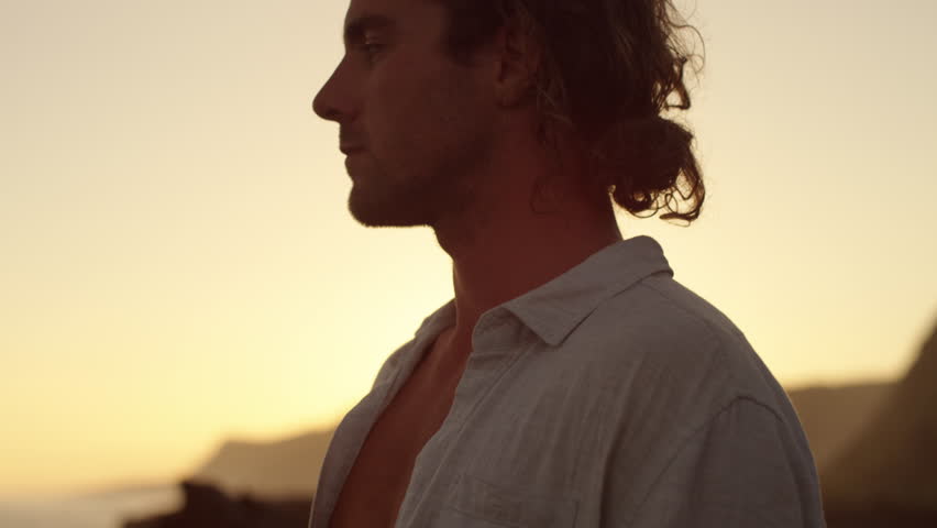 Man looking out onto the horizon at sunset