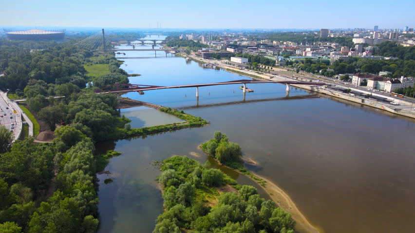 Drone shot on the Vistula river in Warsaw, national stadium and bridges.