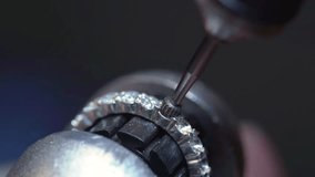 A jeweler, using a special machine, inlays a wedding ring made of gold, silver or other precious metals with diamonds in the jewelry manufacturing and processing workshop - Powered by Shutterstock - Get 15% off with code: PIKWIZARD15
