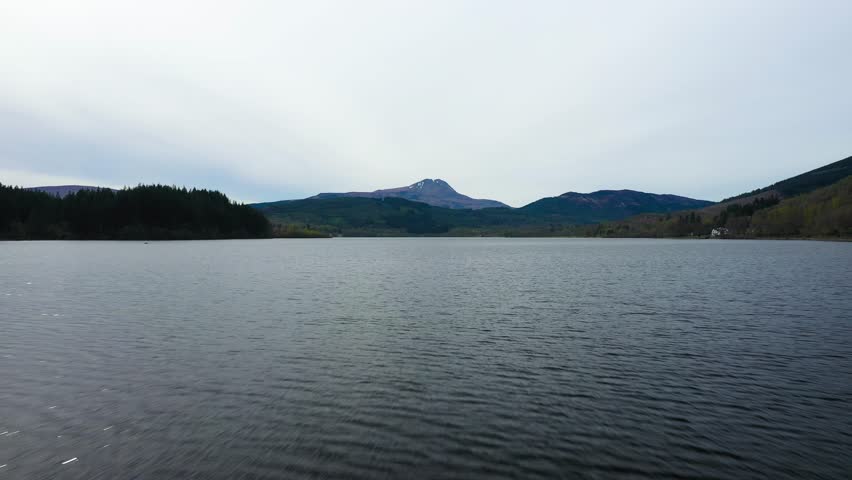 Low aerial video over water of Loch Ard, Trossachs National Park, Scottish Highlands, Scotland, UK