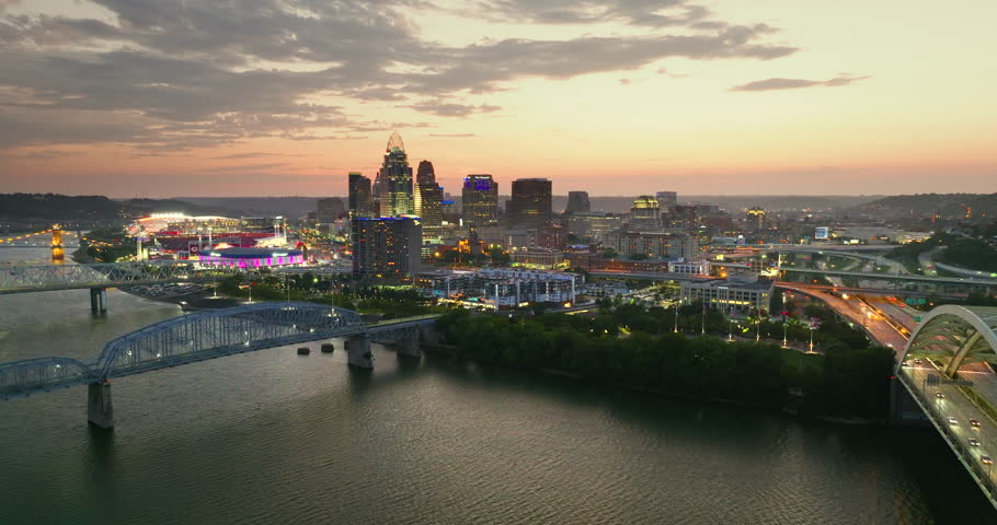 Downtown district of Cincinnati in Ohio, USA at sunset with brightly illuminated high skyscraper buildings. American travel destination.