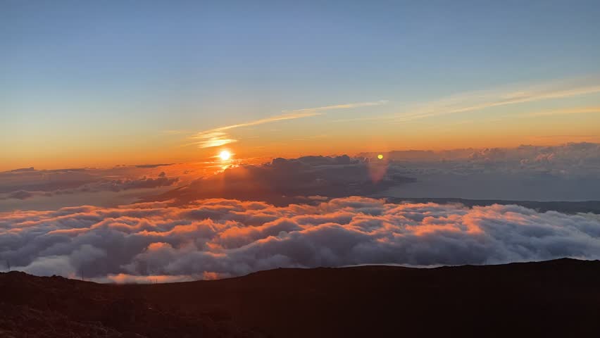A timelapse footage of the clouds moving around the crater dormant Haleakala Volcano at sunset in Maui, Hawaii