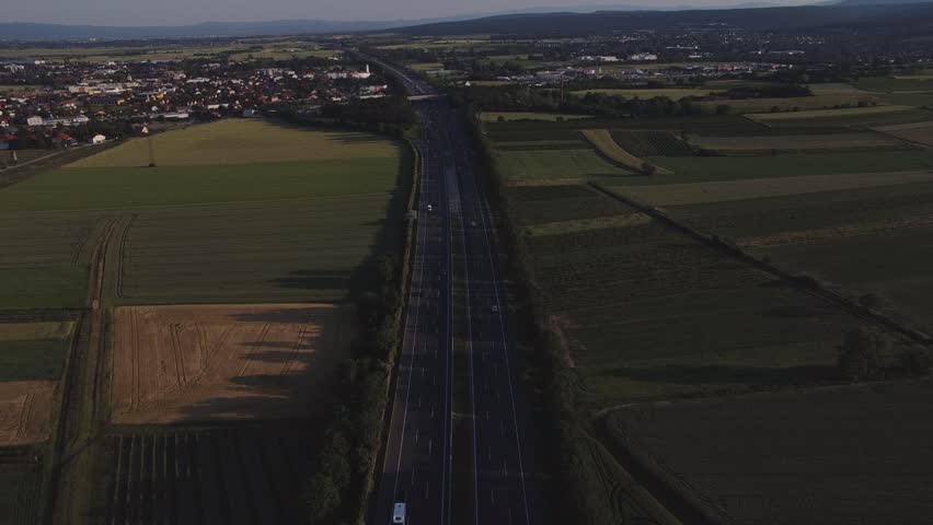 An aerial view of an interstate highway leading to a suburban town.