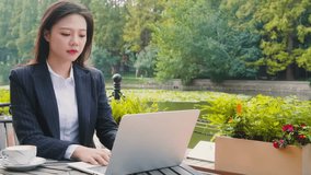 Portrait of a successful, Serious Positive businesswoman reading newspaper or laptop computer and drinking coffee while relaxing outside office building - Powered by Shutterstock - Get 15% off with code: PIKWIZARD15