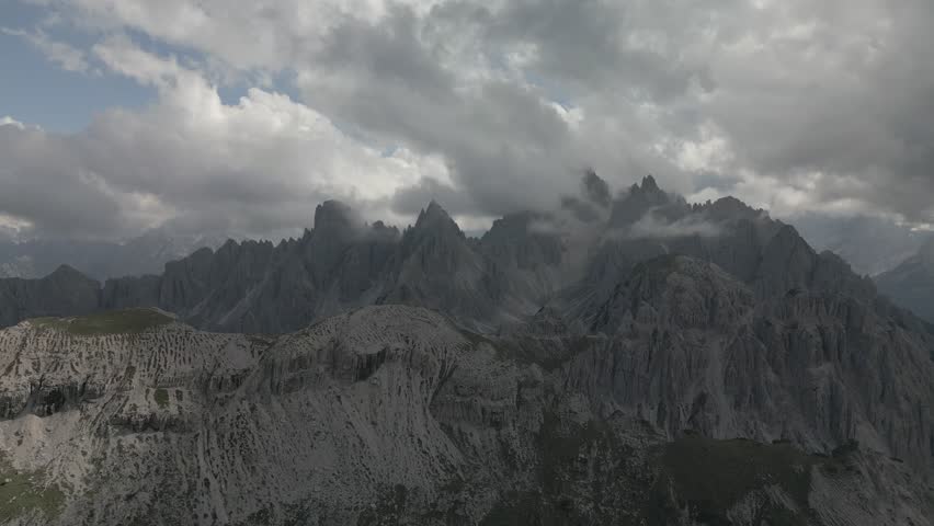 A drone footage of the rocky mountain peaks under a cloudy sky in Wolfenschiessen in the Swiss canton of Nidwalden