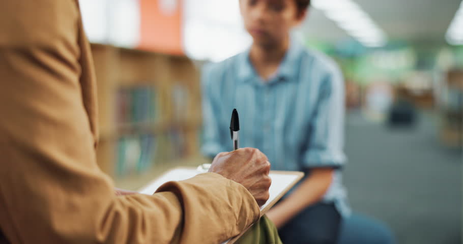 Therapy, clipboard and school counselor with child for adhd test with psychology chart at academy. Consultation, student and educational therapist with kid for learning challenge, autism or dyslexia.