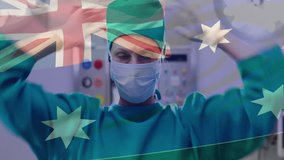 Animation of flag of australia over caucasian female surgeon with face mask. Medicine, patriotism and digital interface concept digitally generated video. - Powered by Shutterstock - Get 15% off with code: PIKWIZARD15