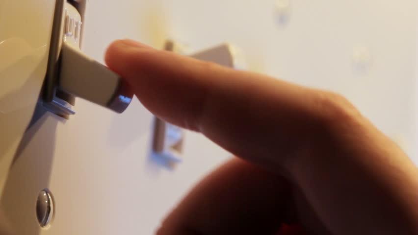 Close up video of multiple light switches being turned on and off, one at a