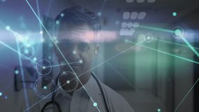 Animation of network of connections with light icons over caucasian male doctor working in hospital. Global medicine, healthcare, connections and digital interface concept digitally generated video. - Powered by Shutterstock - Get 15% off with code: PIKWIZARD15