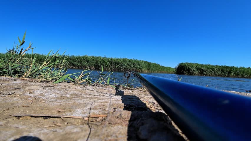 fishing on the river with a fishing rod in sunny weather