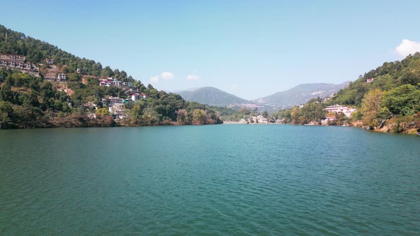 An aerial of a lake in Nainital, Uttarakhand, India on a sunny day