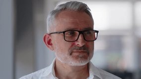 Portrait of handsome male with serious face expression. Close up of caucasian man in looking to camera. Blurred modern office background. Successful middle aged man in formal outfit. - Powered by Shutterstock - Get 15% off with code: PIKWIZARD15