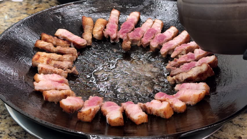 Grilled Korean Samgyeopsal with Kimchi on a Hot Plate