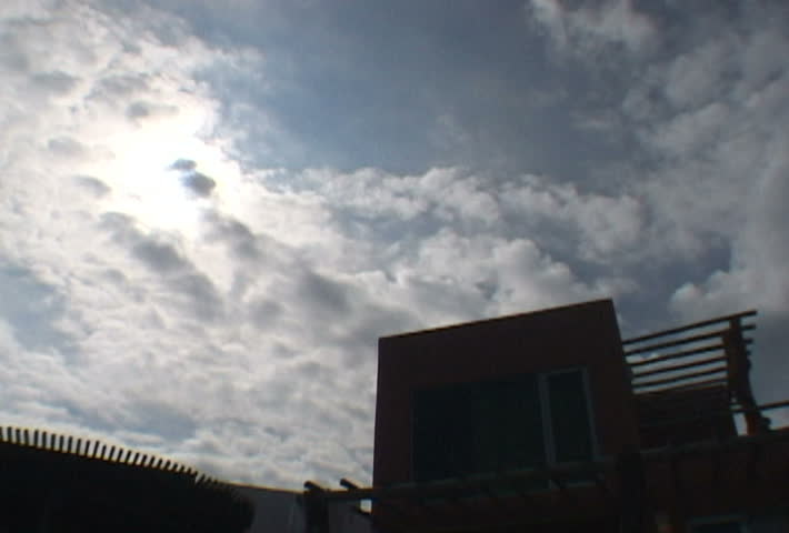 Residential house with time lapse of sun and clouds.