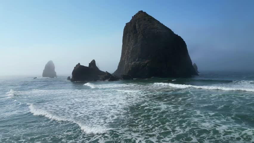 A beautiful view of massive rock formations in the middle of the sea on Canon Beach