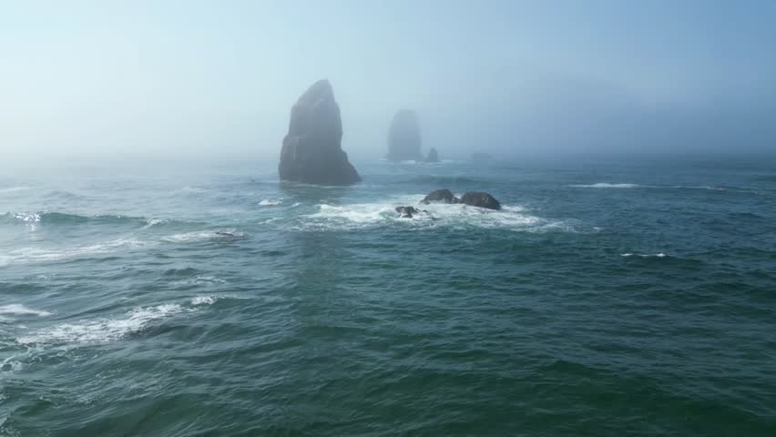A beautiful view of massive rock formations in the middle of the sea on Canon Beach