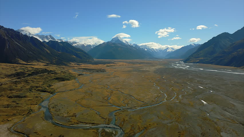 The Tasman River flowing from Mont Cook or Aoraki snow-capped mountain - aerial view