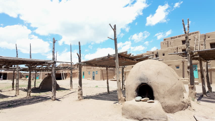 Traditional clay stove in front of adobe style houses in Taos Pueblo, an historic native American pueblo in New Mexico, USA. 