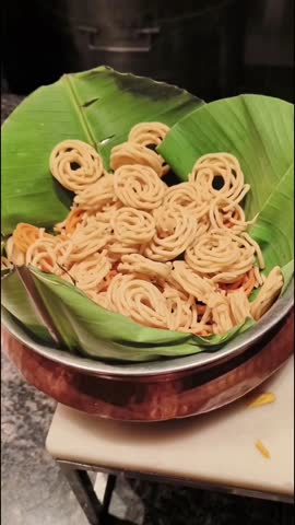 Various types of crackers and crispy chips in different containers, a top view close up video.