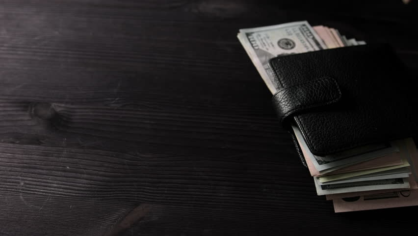 Girl Counting Us Dollars Sticking Out Of Her Wallet And Holding The Wallet