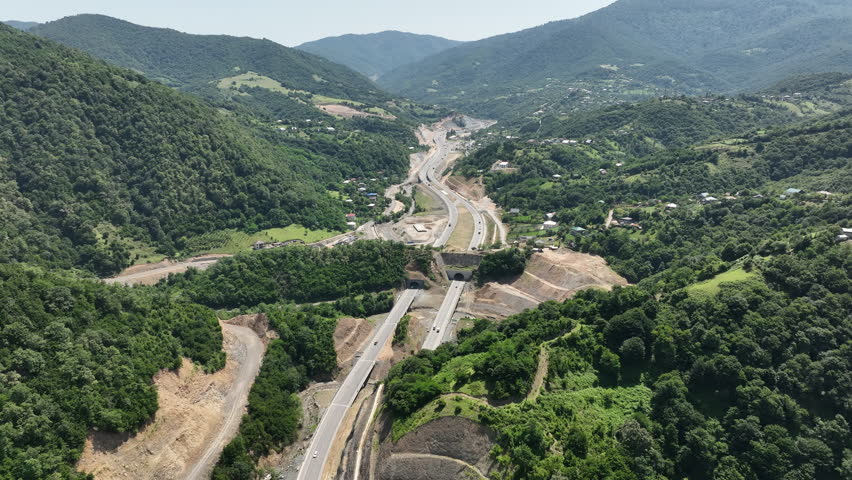 Aerial view of new road through Rikoti pass. Drone shot above highway in mountains of Georgia 2024 summer