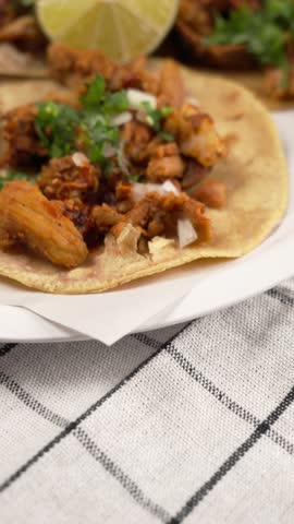 Vertical food video ultra close up of tacos al pastor on a taco shop