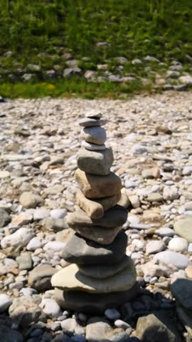 A flying stone destroying stacked stones