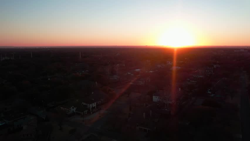 A drone flying towards a beautiful sunset in Dallas, Texas