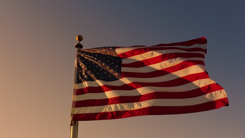 The American flag represents patriotism when its raised at dawn on important days such as Independence Day, Presidents Day, and during elections, proudly fluttering in the morning light