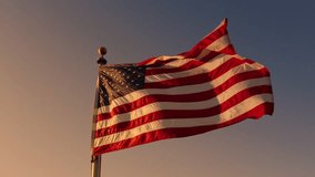 The American flag represents patriotism when its raised at dawn on important days such as Independence Day, Presidents Day, and during elections, proudly fluttering in the morning light - Powered by Shutterstock - Get 15% off with code: PIKWIZARD15